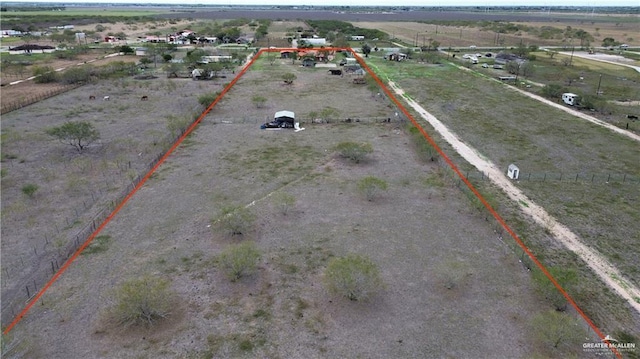 birds eye view of property with a rural view