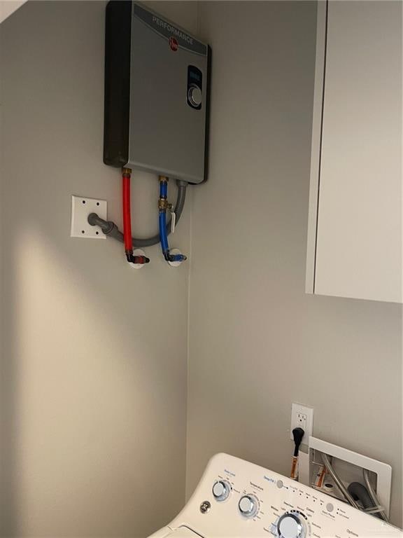 washroom with water heater and washer hookup