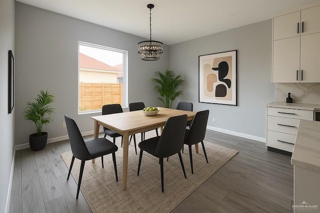 502 Pearl St, Edinburg, TX 78542 - dining room featuring a chandelier, dark wood-type flooring, and baseboards