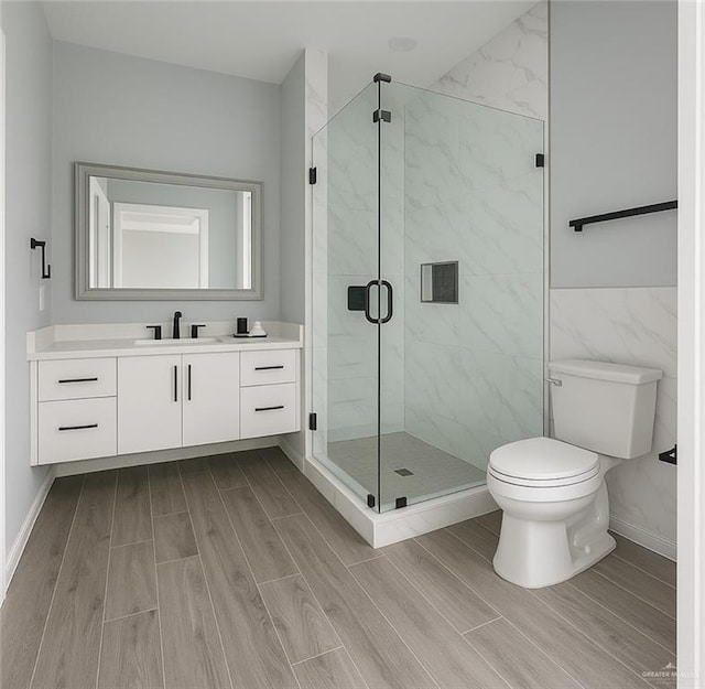502 Pearl St, Edinburg, TX 78542 - bathroom featuring wood tiled floors, toilet, vanity, and a marble finish shower