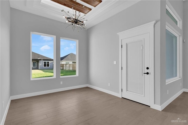 1101 Magnolia St, Mission, TX 78573 - unfurnished dining area featuring a chandelier, wood finished floors, and baseboards