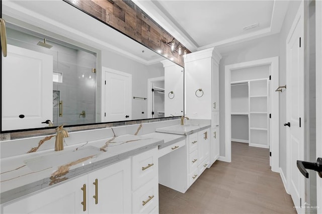 1101 Magnolia St, Mission, TX 78573 - full bath with a stall shower, a walk in closet, double vanity, and wood finished floors