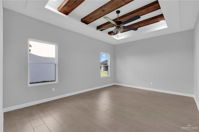 1101 Magnolia St, Mission, TX 78573 - spare room with a ceiling fan, wood finished floors, beamed ceiling, and baseboards