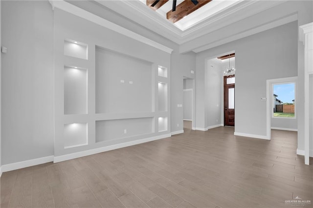 1101 Magnolia St, Mission, TX 78573 - foyer with wood finished floors, a chandelier, a towering ceiling, and baseboards