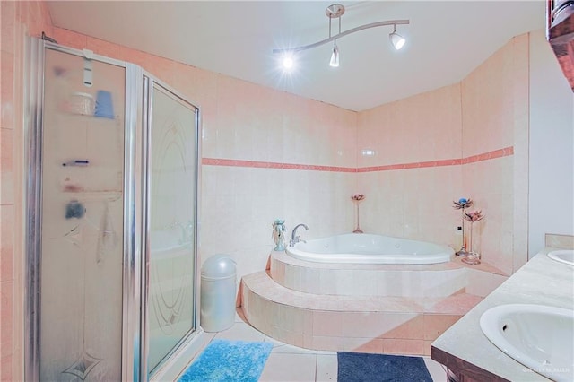1722 Blue Bird Ave, Penitas, TX 78576 - full bath featuring double vanity, a shower stall, a bath, tile patterned flooring, and tile walls