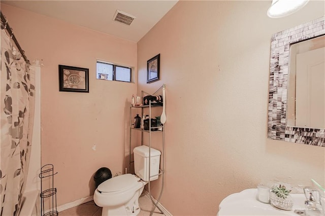 1722 Blue Bird Ave, Penitas, TX 78576 - bathroom with toilet, tile patterned floors, and baseboards
