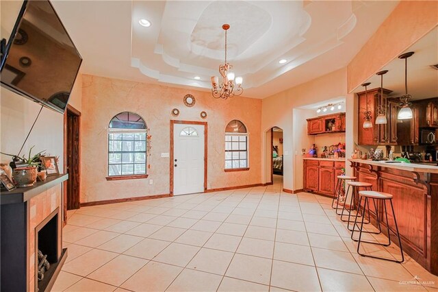 1722 Blue Bird Ave, Penitas, TX 78576 - entrance foyer featuring arched walkways, a chandelier, baseboards, light tile patterned floors, and recessed lighting