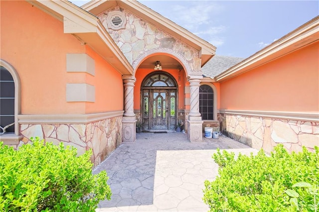 1722 Blue Bird Ave, Penitas, TX 78576 - doorway to property with stone siding, stucco siding, and a shingled roof