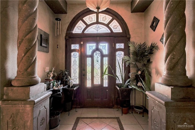 1722 Blue Bird Ave, Penitas, TX 78576 - foyer with inlaid floor details, light tile patterned floors, and arched walkways