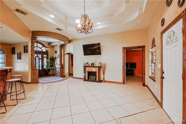1722 Blue Bird Ave, Penitas, TX 78576 - entryway with a chandelier, a fireplace, light tile patterned flooring, arched walkways, and recessed lighting