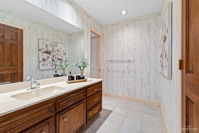 4301 Spring Creek Dr, Corpus Christi, TX 78410 - bathroom featuring wallpapered walls, baseboards, and vanity