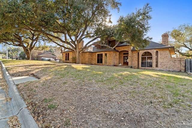 4301 Spring Creek Dr, Corpus Christi, TX 78410 - view of front of home with a chimney and brick siding