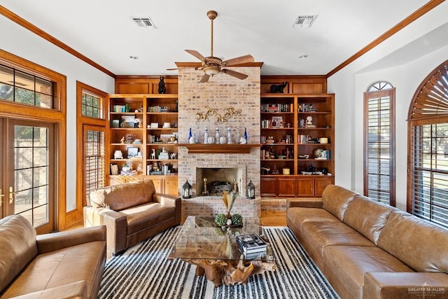 4301 Spring Creek Dr, Corpus Christi, TX 78410 - living area with a ceiling fan, built in shelves, crown molding, and a brick fireplace