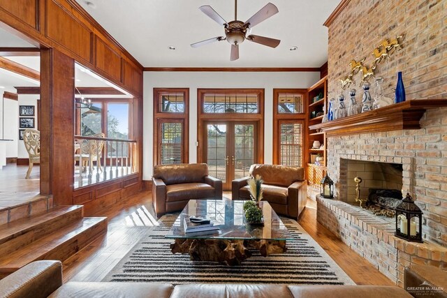 4301 Spring Creek Dr, Corpus Christi, TX 78410 - living room with hardwood / wood-style floors, a ceiling fan, a brick fireplace, crown molding, and built in shelves