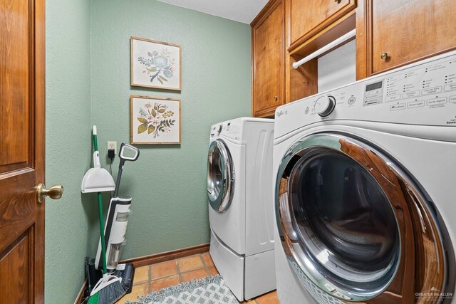 4301 Spring Creek Dr, Corpus Christi, TX 78410 - laundry room featuring cabinet space, washing machine and clothes dryer, light tile patterned flooring, and baseboards