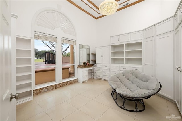 living area featuring a chandelier, light tile patterned floors, and high vaulted ceiling