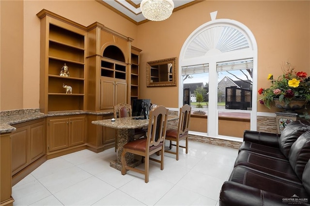 tiled home office featuring a chandelier and crown molding