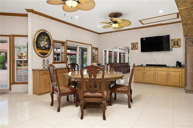 tiled dining area featuring crown molding