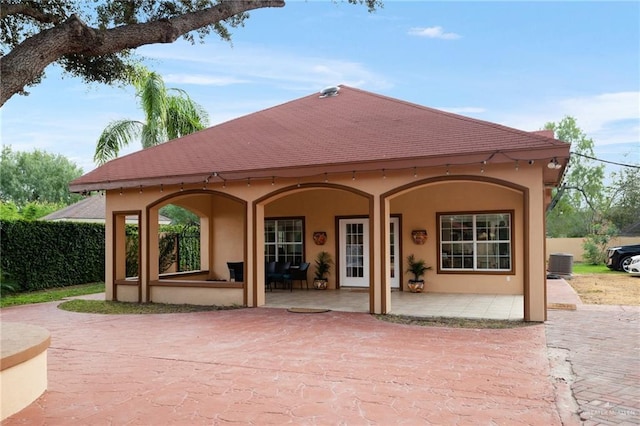 back of house with central AC and a patio area