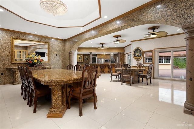 dining space featuring light tile patterned floors, crown molding, and decorative columns