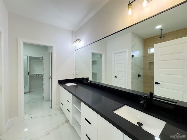 full bathroom with baseboards, double vanity, a sink, a walk in shower, and marble finish floor