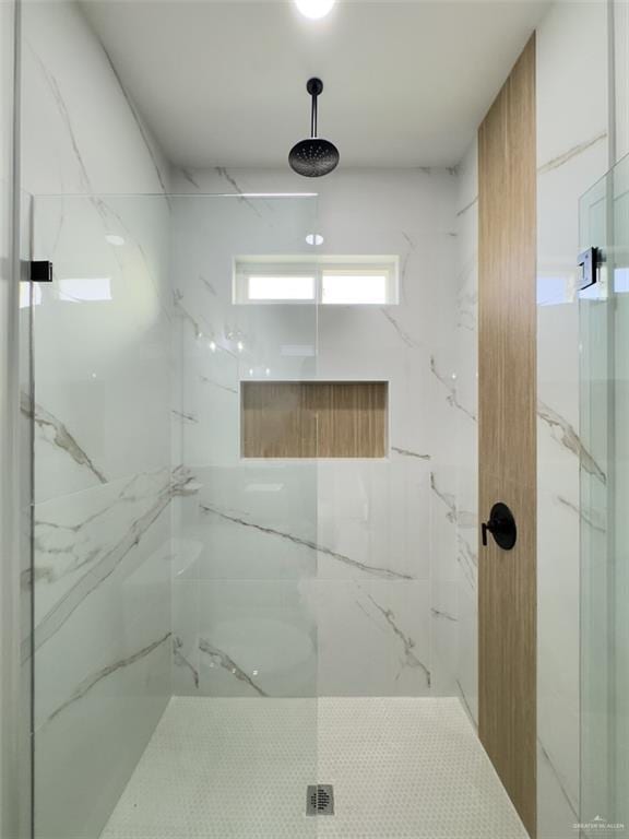 full bath with a marble finish shower