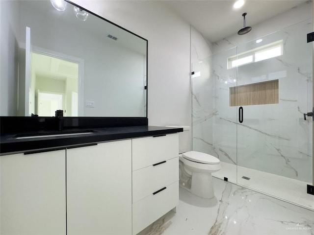 bathroom with a marble finish shower, marble finish floor, toilet, and vanity