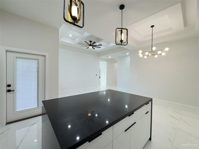 kitchen featuring marble finish floor, a ceiling fan, coffered ceiling, dark countertops, and white cabinetry