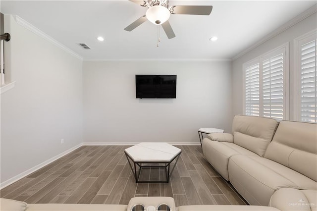 living room with baseboards, visible vents, wood finish floors, and crown molding