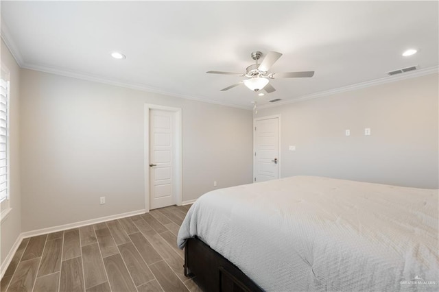 bedroom with baseboards, visible vents, wood finished floors, and ornamental molding