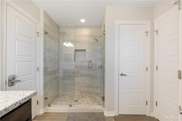 full bathroom featuring vanity, recessed lighting, and a shower stall