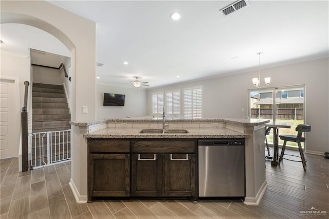 kitchen featuring visible vents, dishwasher, dark brown cabinetry, a sink, and a healthy amount of sunlight