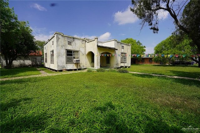 view of front facade featuring cooling unit and a front lawn