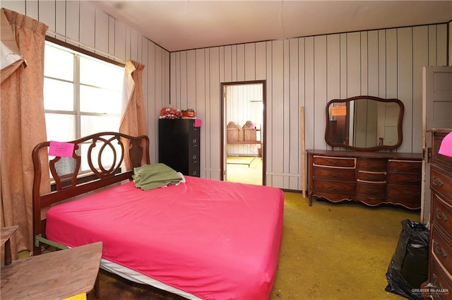 carpeted bedroom with wooden walls