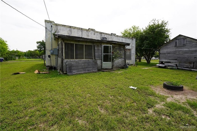 rear view of house with a lawn