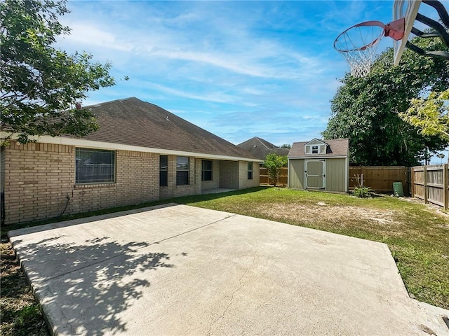 700 Via Cantera Dr, San Juan, TX 78589 - rear view of house with a patio area, brick siding, and roof with shingles