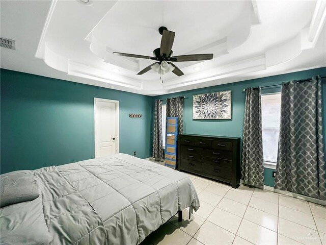 700 Via Cantera Dr, San Juan, TX 78589 - bedroom with a tray ceiling, ceiling fan, and tile patterned floors