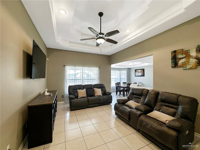 700 Via Cantera Dr, San Juan, TX 78589 - living area featuring a ceiling fan, a tray ceiling, light tile patterned floors, and baseboards