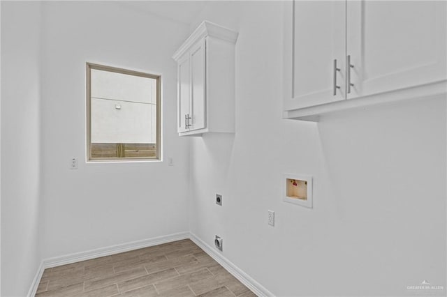 washroom with cabinets, washer hookup, and electric dryer hookup