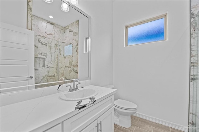 bathroom featuring vanity, toilet, and a shower with door