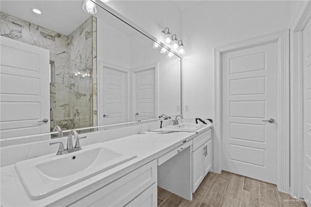 bathroom featuring vanity and a shower with shower door