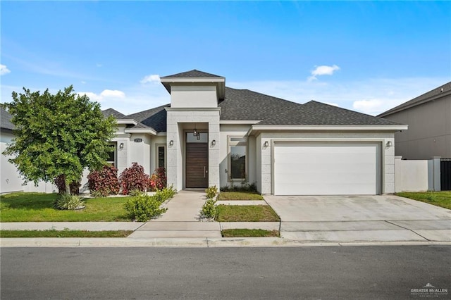 prairie-style house featuring a front yard and a garage