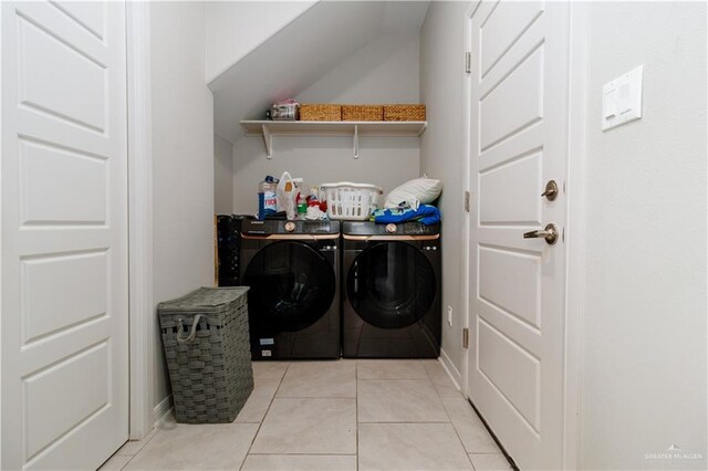 clothes washing area featuring separate washer and dryer, light tile patterned floors, and baseboards
