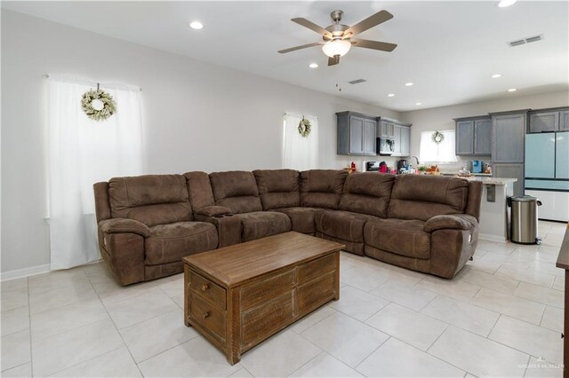 living area featuring ceiling fan, recessed lighting, and light tile patterned floors