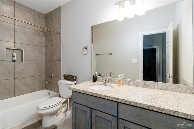 bathroom featuring toilet, tile patterned floors, vanity, and shower / washtub combination