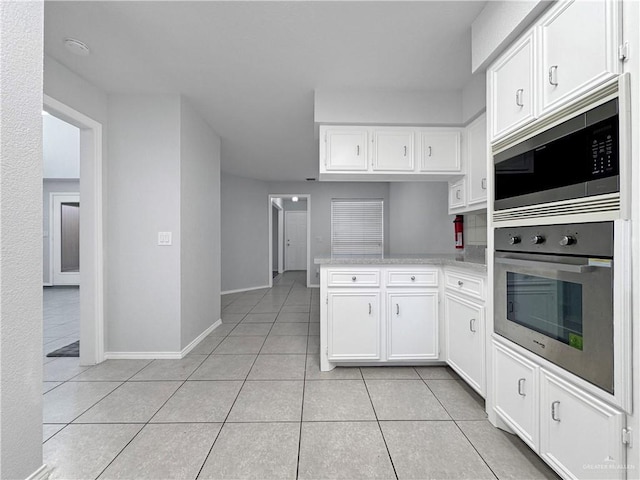 kitchen featuring white cabinetry, light tile patterned flooring, and appliances with stainless steel finishes