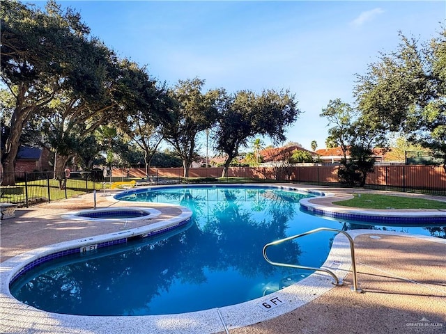 view of pool with an in ground hot tub