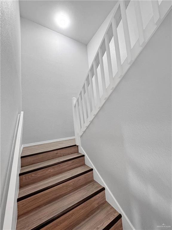 staircase with wood-type flooring