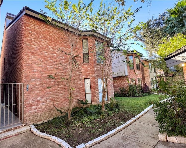 view of side of home with a yard