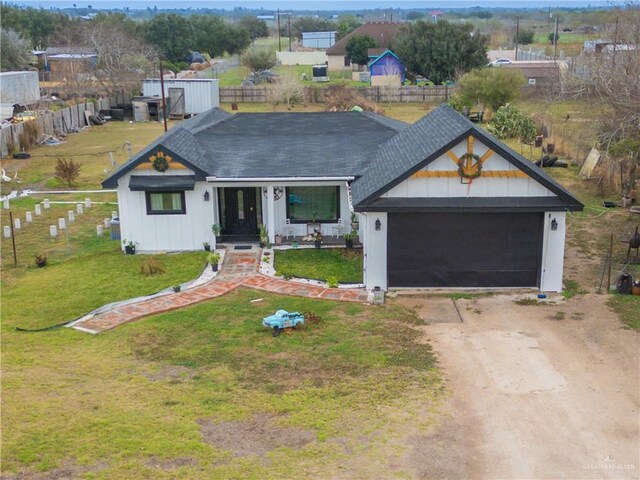 modern farmhouse style home featuring a garage and a front lawn